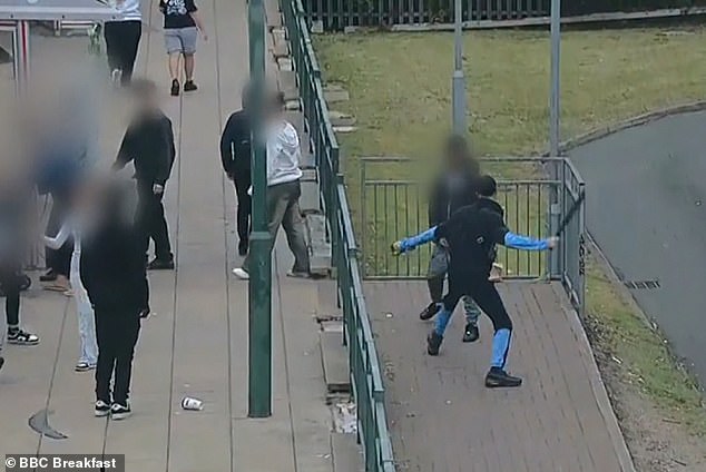 Transport staff in the West Midlands say they are experiencing a growing trend of antisocial behaviour on public transport. Pictured: A group of youths brawl outside a butstop in the West Midlands