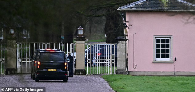 Cars wait at the entrance to Royal Lodge, a 30-room property and former residence to Britain's former prince Andrew where police said they are still conducting a search, in Windsor, west of London on February 20, 2026, a day after Andrew Mountbatten-Windsor was arrested on the royal family's remote Sandringham estate in eastern England. Britain's royal family was thrown into crisis on February 19 after former prince Andrew was arrested by police and held for hours, in a blow to the monarchy unprecedented in modern British history. (Photo by Ben STANSALL / AFP via Getty Images)