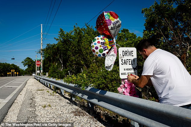 Attorneys for the family argued that Tesla's Autopilot feature contributed to the crash. The company's representation disputed that claim, arguing that Autopilot does not prevent reckless driving. Angulo is pictured August setting up a roadside memorial for his girlfriend