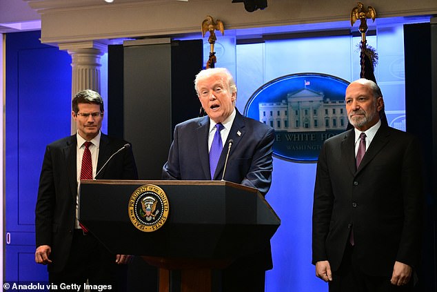 Pictured: US Solicitor General John Sauer (left) and Secretary of Commerce Howard Lutnick (right) flanked Trump as he came to speak with the press about his tariffs