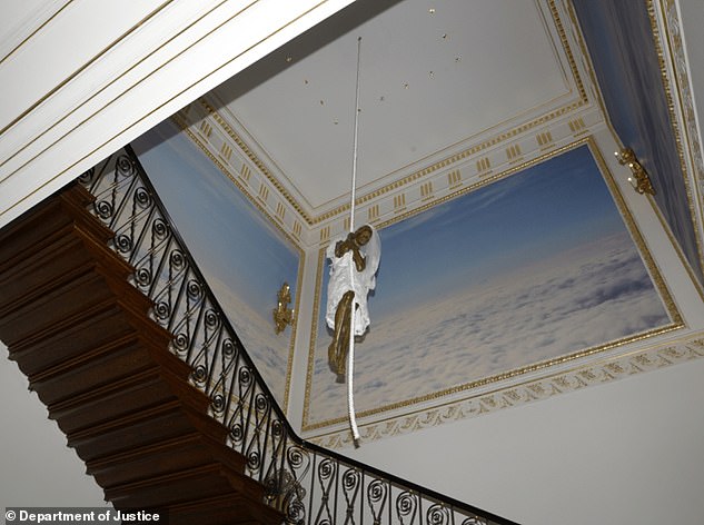 The home also featured art of a bride statue  hanging from a rope above a spiral staircase