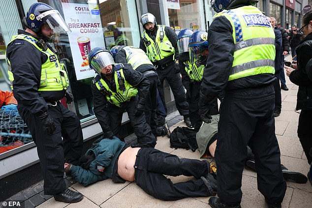 Counter-protesters are dragged away by police during the organised by far-right group Britain First