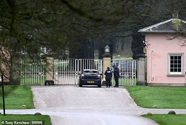 Police officers are seen at the gates of Andrew's former home, Royal Lodge in Windsor