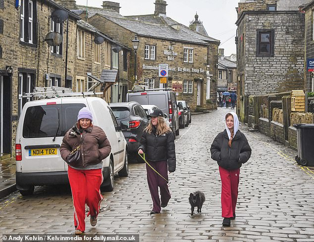 Local traders told the Daily Mail how they are drawing up plans for an unprecedented influx of day-trippers and holidaymakers from around the world. Pictured: L-R Joanna Williams, her niece Freya and her daughter Esme-Rose on a visit to Haworth from Hull