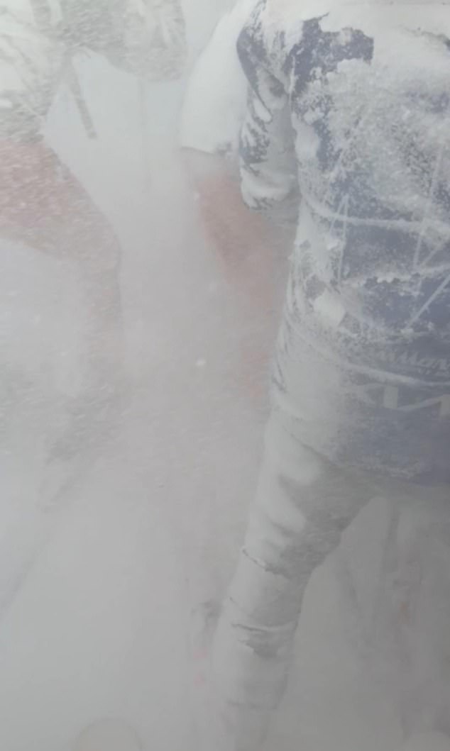 Video grab shows people coming to the skier's rescue after he was buried under snow