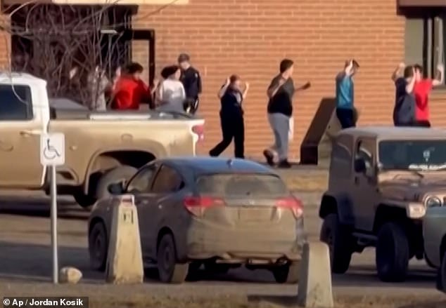 Children were led out of the school after the shooting as authorities attended the scene