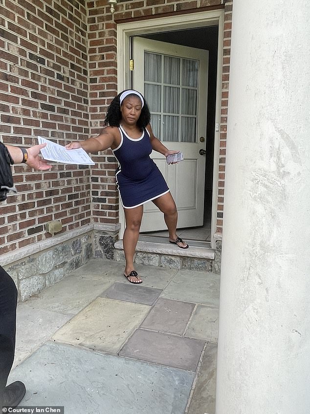 Goode is seen being served legal papers outside her house before she was finally evicted once and for all earlier this month