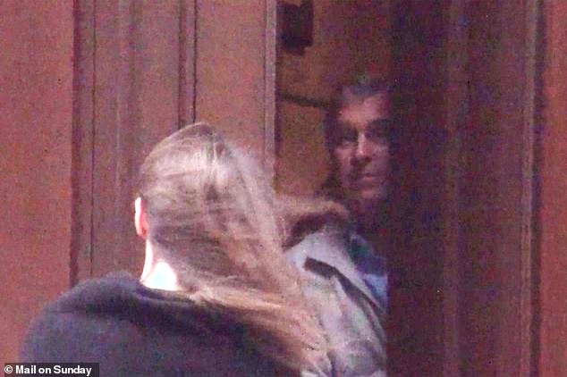 Andrew waves goodbye to a woman leaving Epstein's home in New York in December 2010