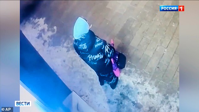 Image made from video provided by Russian Federal Security Service via Russia-1 TV channel on Sunday, Feb 8, 2026, CCTV footage showing a person standing outside a building, suspected in the attempted murder of Lt. Gen. Alekseyev