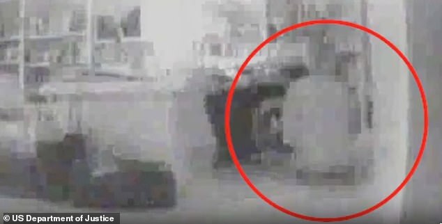 Grainy footage appears to show a young woman kneeling by Jeffrey Epstein's desk. It is unclear when the footage was recorded, but in 2005, police raided Epstein's Palm Beach mansion and discovered a camera inside a clock hidden in his office, and found another in his garage