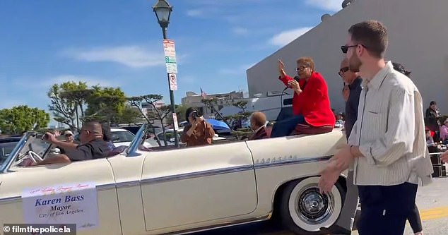 Karen Bass is mercilessly booed by her own constituents as she rides around LA in the back of a swanky white convertible