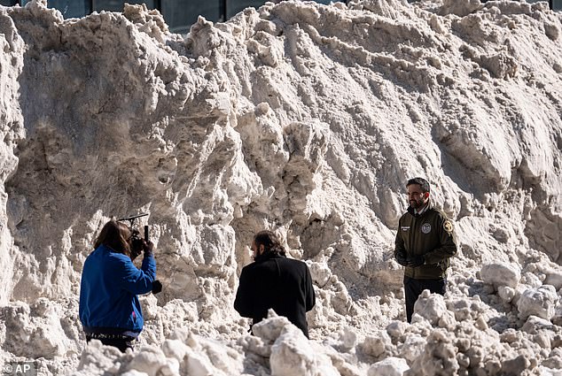 Mayor Mamdani stands in front of a perilous mound of snow from the city's last storm