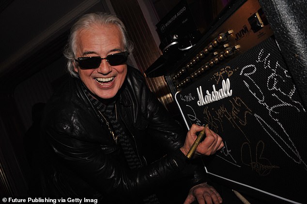 Led Zeppelin's Jimmy Page signs a Marshall amp at the Classic Rock Awards afterparty in London in 2009