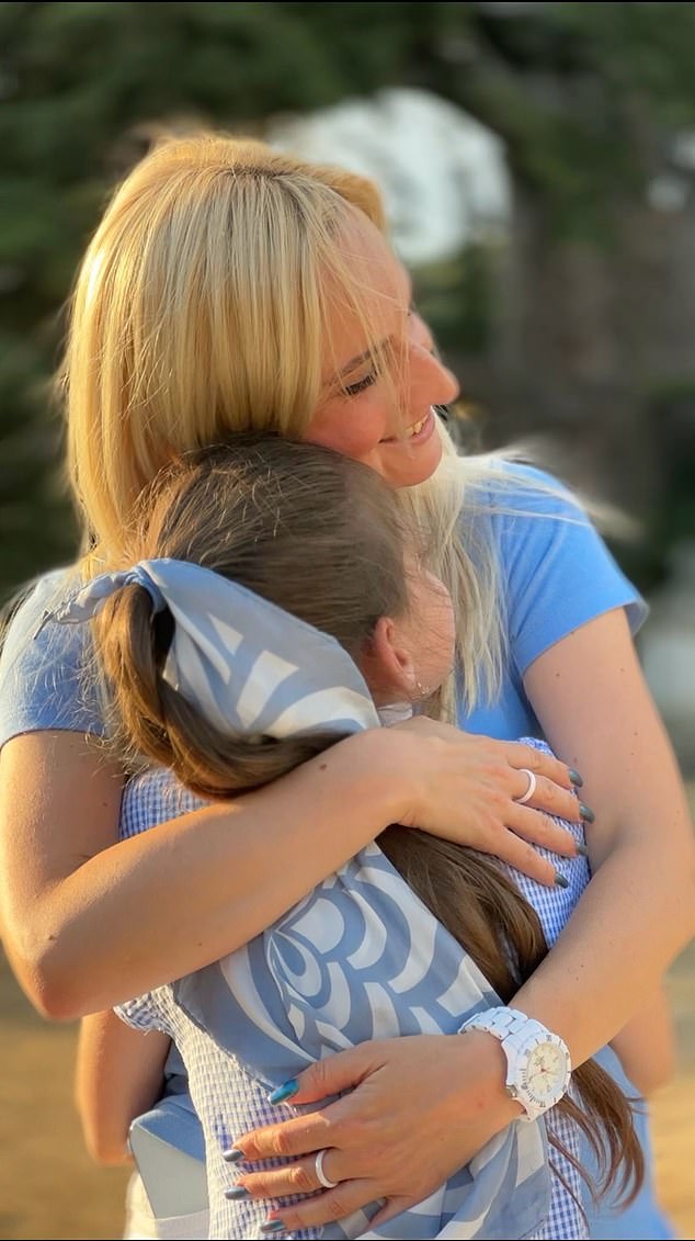 Ms Kolesnikovych embraces her daughter. While she  admits initially the plan was to return to Ukraine after a year, for the sake of her daughter she would like to stay in the UK for now