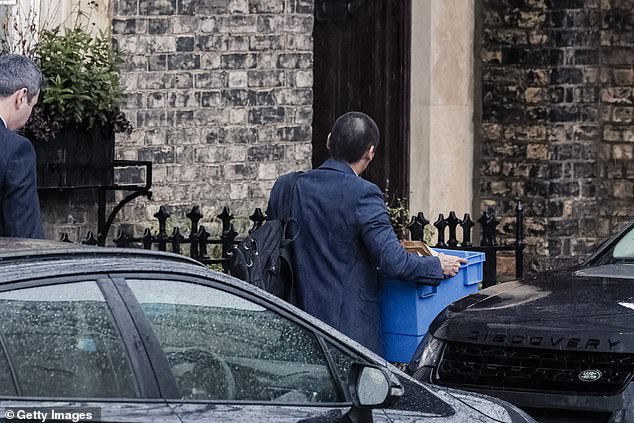 A police officer carrying a blue box walks towards the front door of Peter Mandelson's house earlier in February when they were being searched