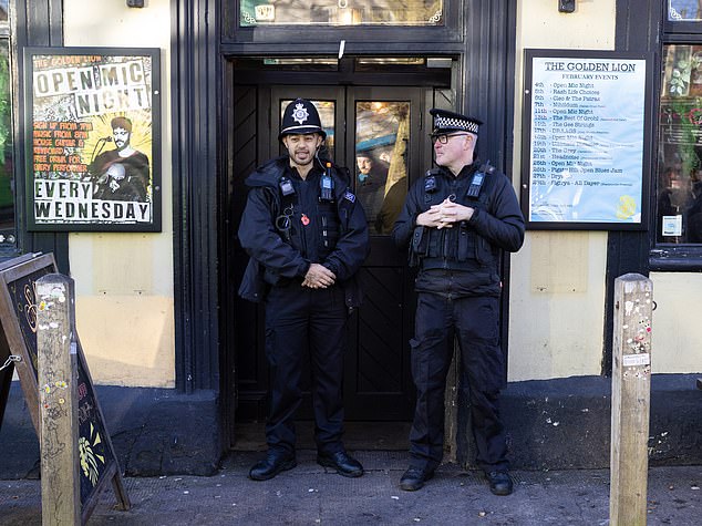 Police standing outside of the Golden Lion pub in Horfield Bristol, where pro-Palestinian protesters had gathered
