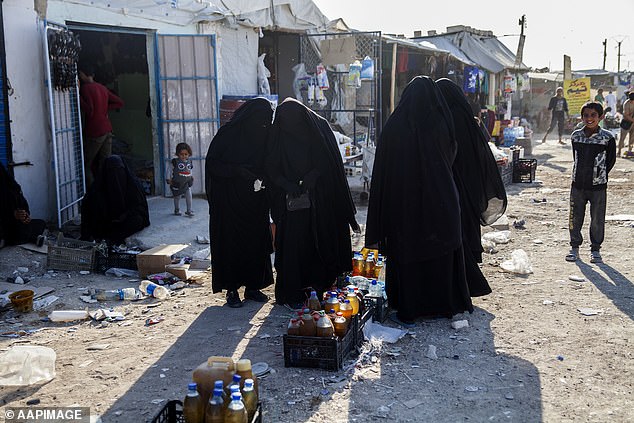 Pictured: Women buying food at the Iraqi market in Al Hawl refugee camp in Syria