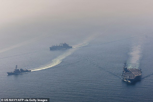 Nimitz-class aircraft carrier USS Abraham Lincoln sails alongside Arleigh Burke-class guided-missile destroyer USS Frank E. Petersen Jr. and Lewis and Clark-class dry cargo ship USNS Carl Brashear in the Arabian Sea