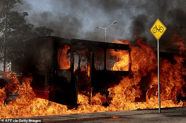 A bus set on fire by organised crime groups in response to an operation in Jalisco to arrest a high-priority security target, burns at one of the main avenues in Zapopan, state of Jalisco