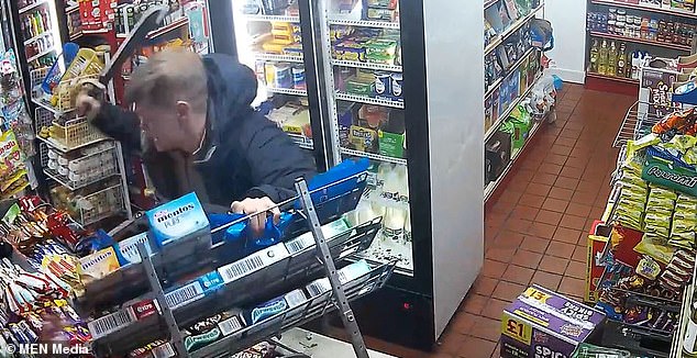 Moment thug launches machete attack in local shop as mother and children forced to cower in terror