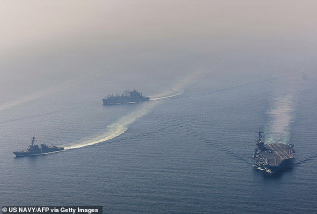 USS Abraham Lincoln sails alongside USS Frank E Petersen Jr and USNS Carl Brashear in the Arabian Sea on February 6