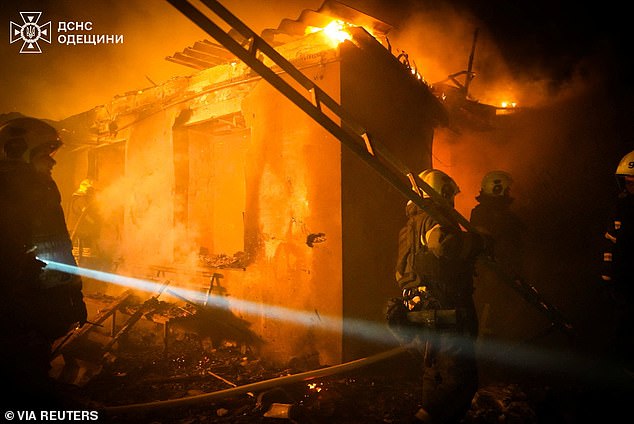 Firefighters work at the site of a residential area hit by Russian drone strikes, amid Russia's attack on Ukraine, in Odesa, Ukraine February 21, 2026