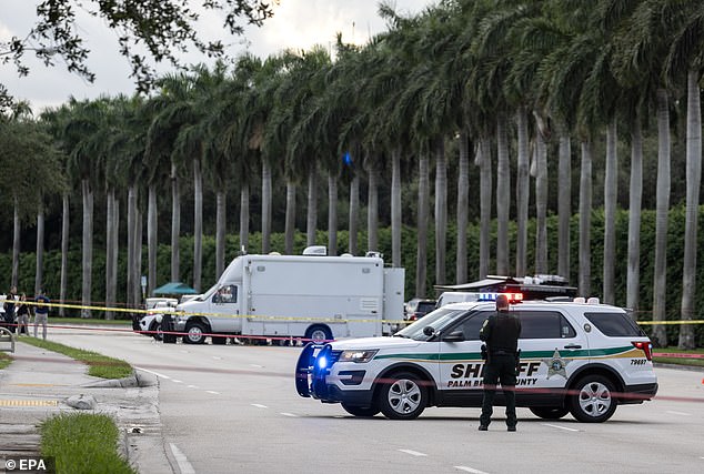 Palm Beach Sheriff officers guard the rear entrance of the Trump International Golf Club in West Palm Beach