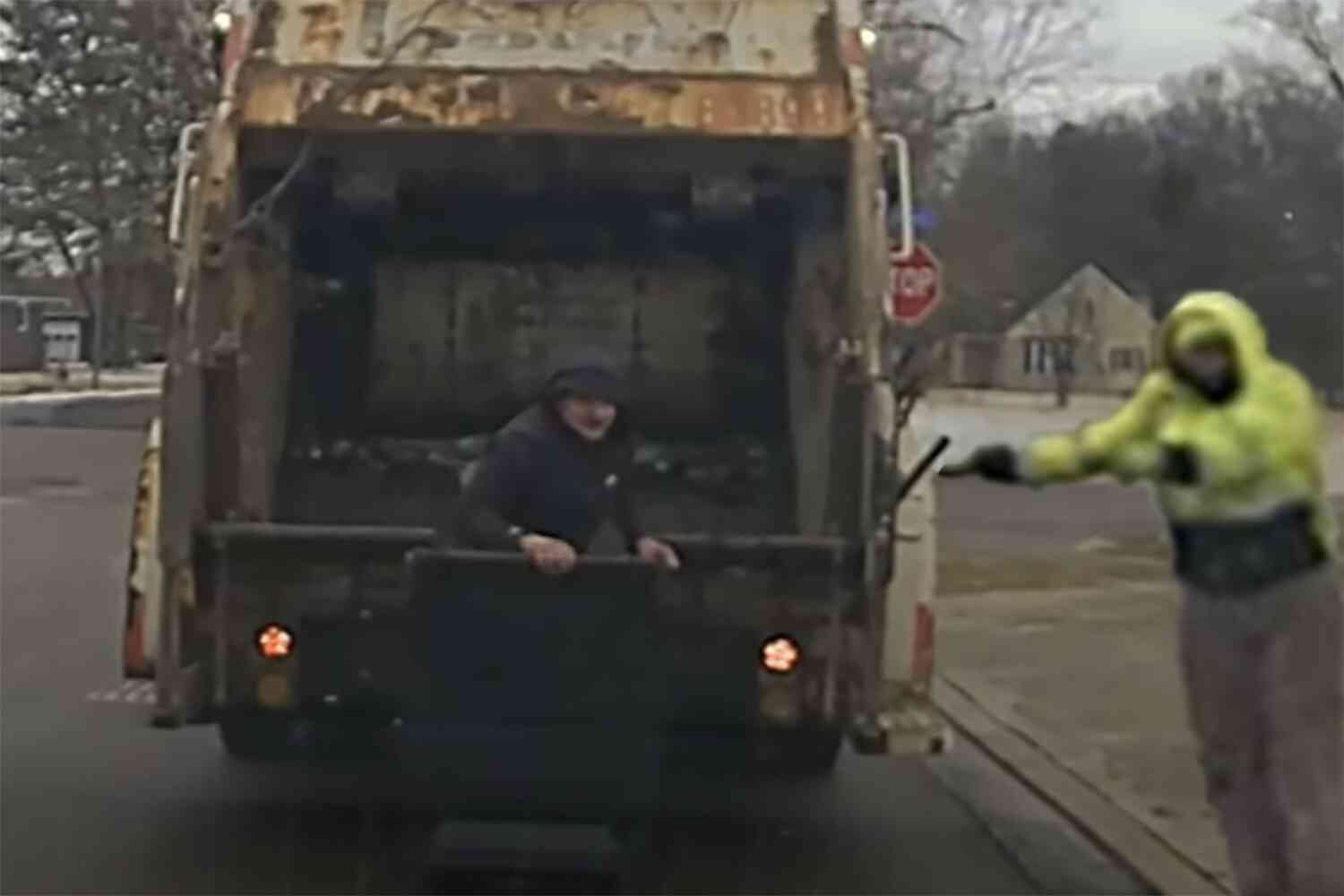 Watch this garbage man find a police suspect hiding in a trash can