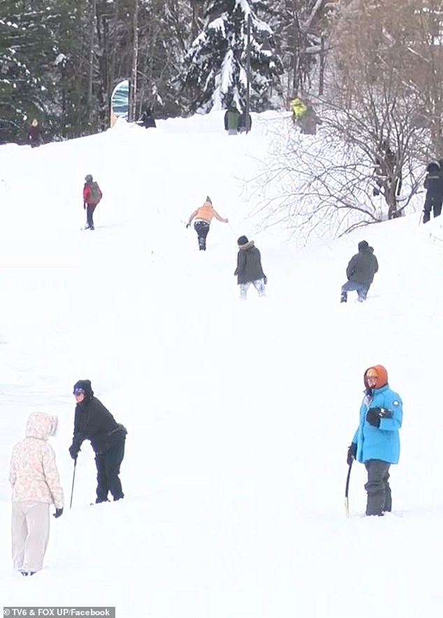 Hundreds of people have helped joined the search for the missing student many carrying sticks and tools to pokes mounds of snow
