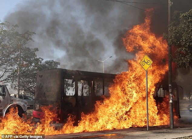A bus burns on one of the main avenues after it was set on fire by organised crime groups in response to an operation in Jalisco