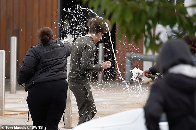 People spray sparkling wine over a man who walked out of Nottingham Prison on September 10, 2024 - the day Labour's existing early release scheme came into effect