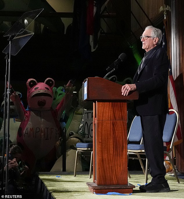 Attendees dressed as frogs (left) can be seen at the 'State of the Swamp' headlined by actor Robert De Niro (right) Tuesday night, counter-programming the State of the Union address