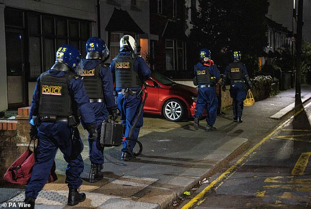 City of London Police officers during a raid at a property in London used by a suspected member of a phone snatching gang