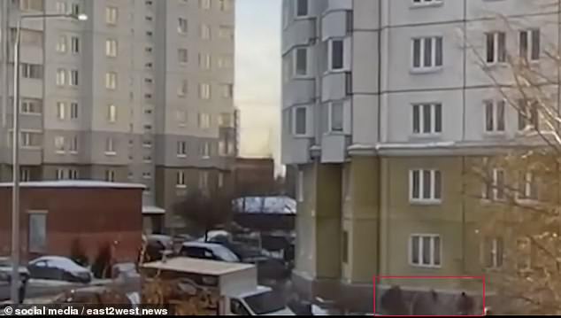 Footage shows the 18-month-old teetering on a windowsill of a residential block in St Petersburg, before losing his grip and plunging towards the ground
