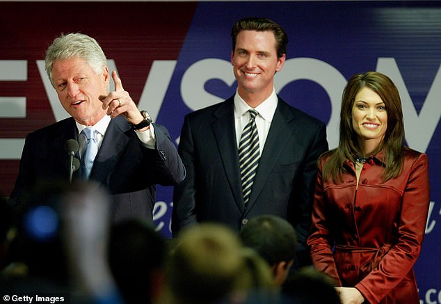 California Governor Gavin Newsom (center), who was then running for mayor of San Francisco, stands alongside his wife Kimberly Guilfoyle (right) and former President Bill Clinton (left) at a campaign event in 2003