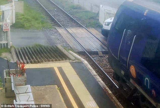 Moment train smashes into van when delivery driver pulled onto level crossing after opening gates by hand