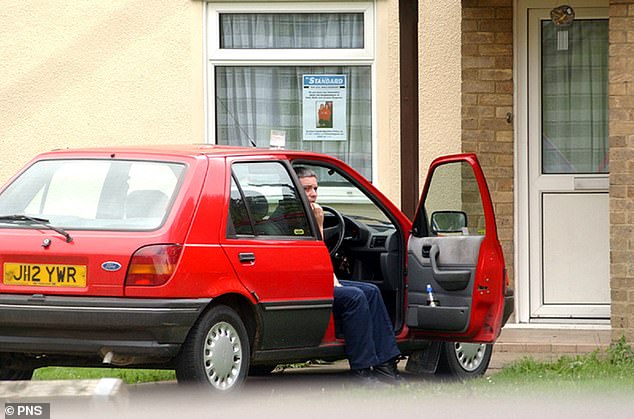 The school caretaker (pictured, outside his home in August 2002) murdered the girls, before dumping their bodies in a ditch some 12 miles away. He would later return and attempt to set fire to them