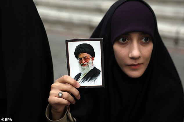 An Iranian woman holds a picture of Iranian Supreme Leader Ayatollah Ali Khamenei during anti-US and Israeli protests in Tehran, February 28, 2026