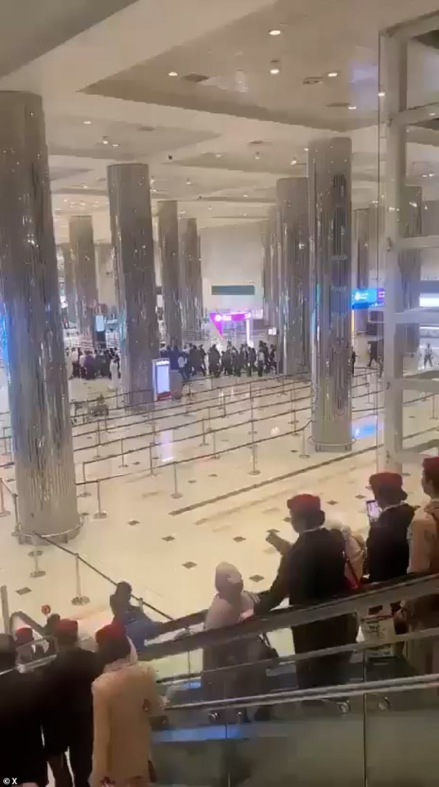 Images show passengers leaving the airport in Dubai after one its terminals was hit by an Iranian drone