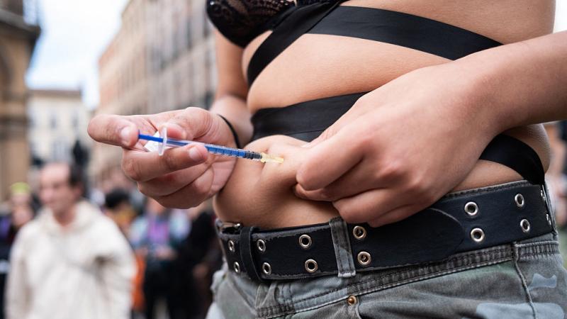 Transgender person injects self with estrogen
