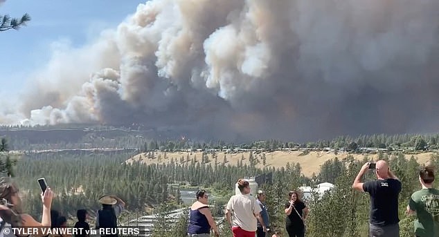 Smoke rises over Spokane, Washington as the Old Trails Fire spreads rapidly through dry terrain during a dangerous heat wave