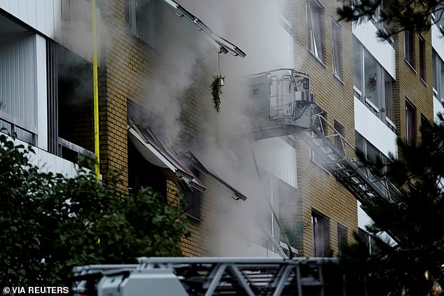 Smoke billows out of windows after the explosion in the Annedal area of central Gothenburg, Sweden, 2021