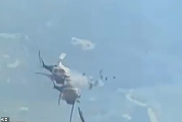 Striking footage shows one of the aircraft slowly approaching the other - before their propellers clash and the helicopter erupts into a fireball and plummets to the ground