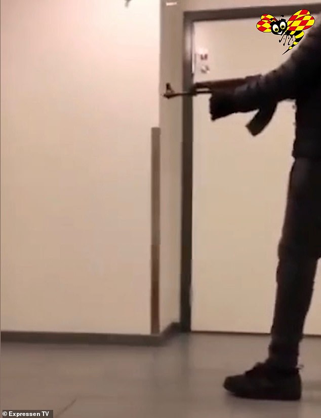 A teenager is pictured armed with a Kalashnikov assault rifle, spraying bullets into the house of the ex-girlfriend of a well-known rapper as a scare tactic in another scene of gangland violence