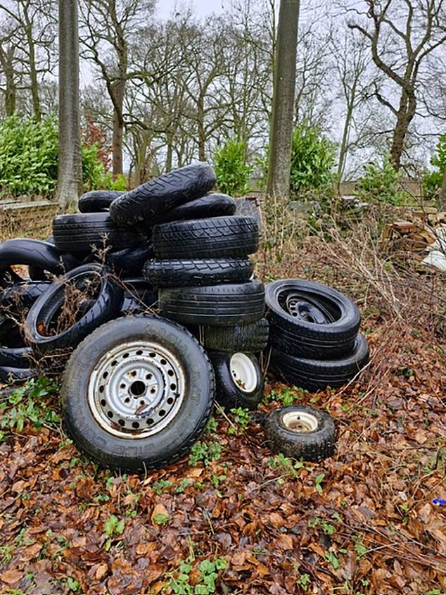 A pile of broken car tyres are pictured abandoned on Earl Spencer's estate