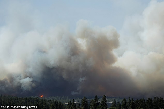 Firefighters battle the blaze as extreme weather conditions make efforts to contain the wildfire increasingly challenging