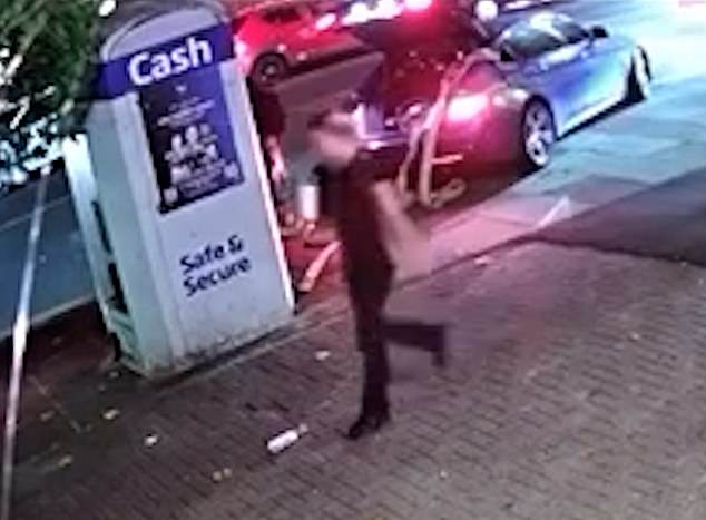 A woman on her phone walked past the brazen thieves as they hooked up the cash machine to the car