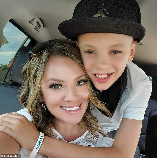 Miller, from Goddard, Kansas, developed painful blood clots in her legs after she was swarmed by about 15 arachnids during a vacation to Cheney Lake. She is pictured with one of her sons