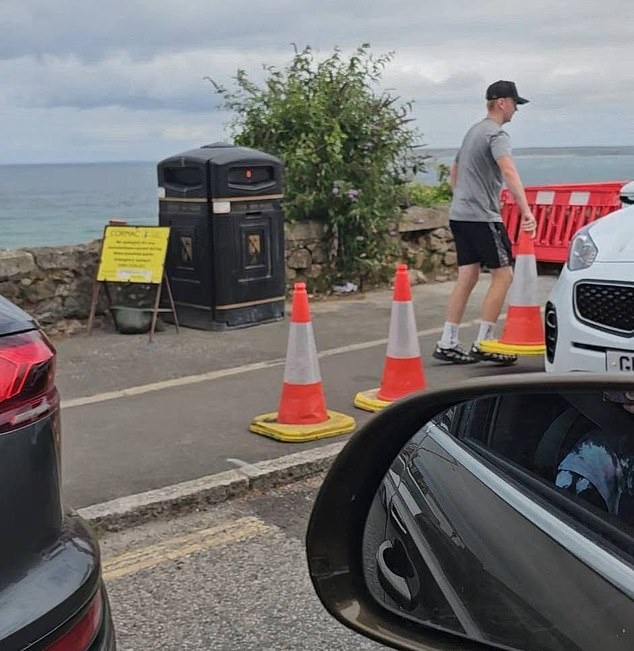 Another local caught a man moving traffic cones out of the road so that he could park there