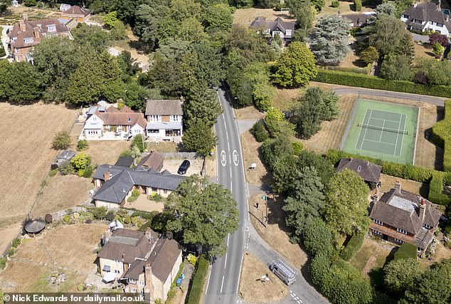 An aerial view shows the brown lawns belonging to a cluster of homeowners on Hosey Hill, Hosey Common Road, governed by Thames Water